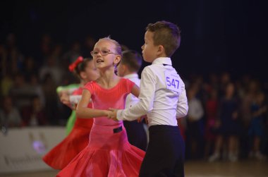 Küçük kız ve oğlan balo salonunda çift olarak dans ediyorlar. Yardım balosu. 20 Ekim 2021. Kyiv, Ukrayna