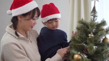 Parents and children with Christmas tree decorations