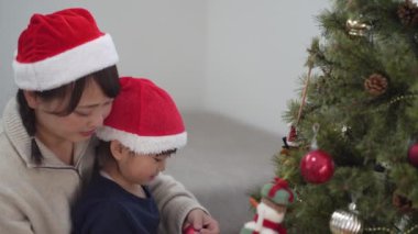 Parents and children with Christmas tree decorations