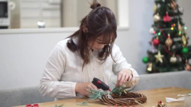 Woman making a Christmas wreath