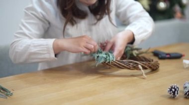 Woman making a Christmas wreath