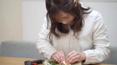 A woman making New Year's decorations