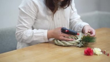 A woman making New Year's decorations