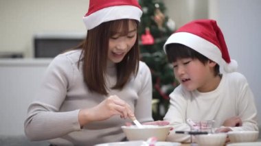 Parent and child building a Hexenhaus