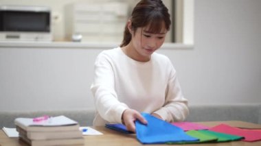 Woman studying colors at home