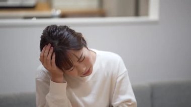 woman feeling a headache