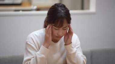 woman feeling a headache