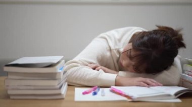 woman taking a nap while studying