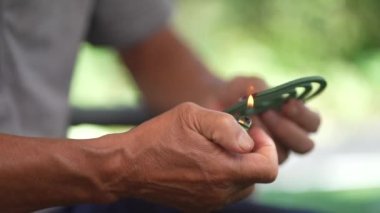 A man lighting a mosquito coil