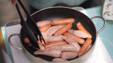 Image of a woman baking sausages