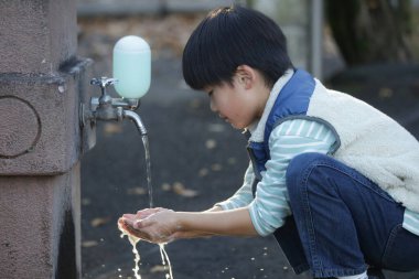 Boy washing his hands image