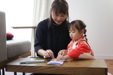 Parents and children making Chitose candy bags