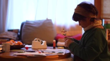 A woman making New Year's decorations by hand