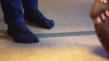 A woman sweeping a tatami mat