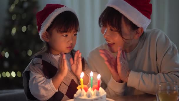 Parent Child Blowing Out Candle Flame — ストック動画