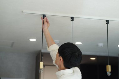 man installing lighting fixtures