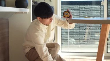 man measuring table height