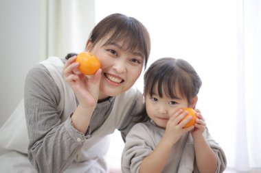 Parent and child with oranges