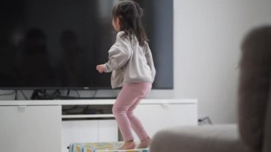 Girl playing on an indoor trampoline