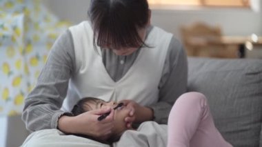 mother brushing child's teeth