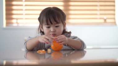 Girl eating oranges Image