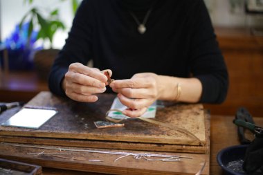 A woman making a stained glass work