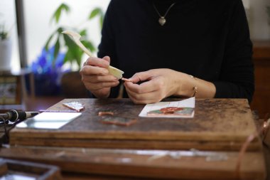 A woman making a stained glass work