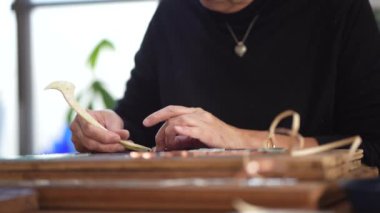 A woman making a stained glass mirror