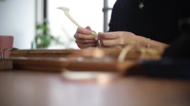 A woman making a stained glass mirror