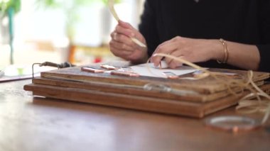 A woman making a stained glass mirror