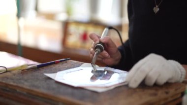 A woman making a stained glass mirror