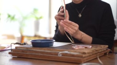 A woman making a stained glass work
