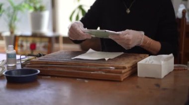 A woman making a stained glass work