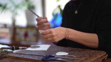 Image of a woman cutting a paper pattern