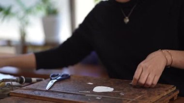 Image of a woman cutting a paper pattern