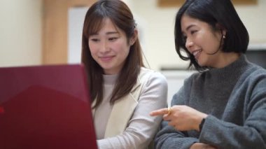 woman looking at photos on computer