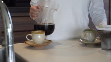 Kahve yapan bir kadın resmi.