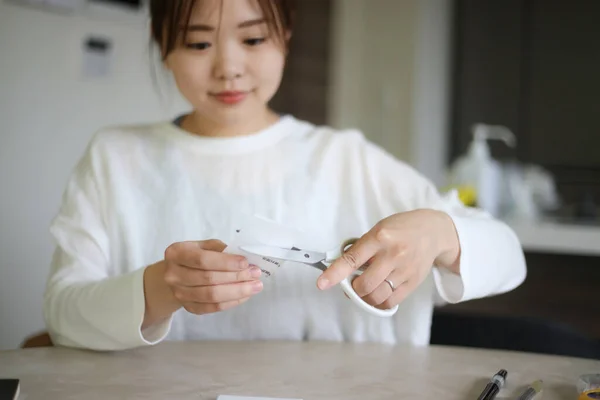 A woman who cuts the documents with scissors