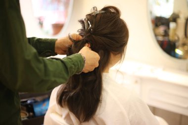 Güzellik salonunda saçını yaptıran bir kadın.