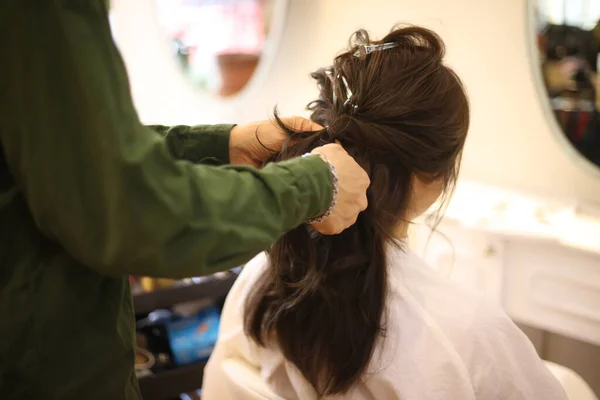 A woman getting her hair done at a beauty salon