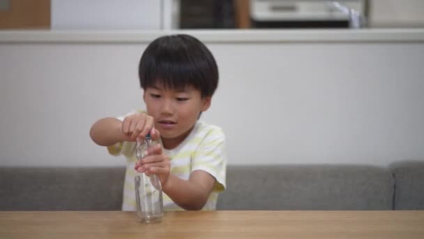 Bir Çocuk Ramune Şişesinden Misket Çıkarmaya Çalışıyor — Stok video