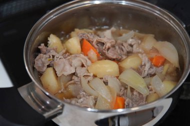 Making Nikujaga (beef and potato stew) clipart
