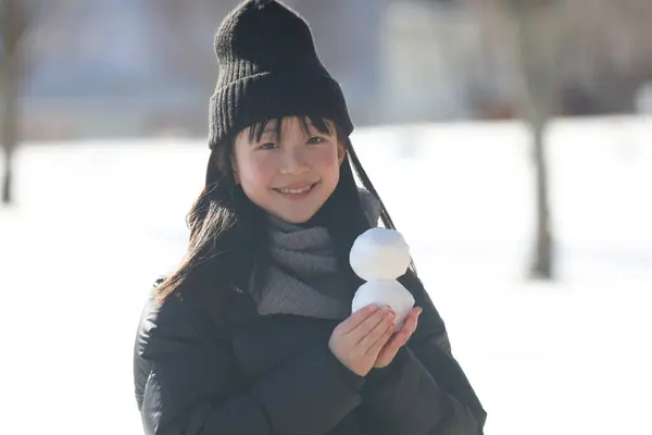 stock image Image of a girl holding a snowman