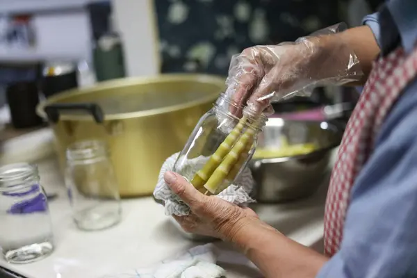 stock image A woman bottling bent bamboo