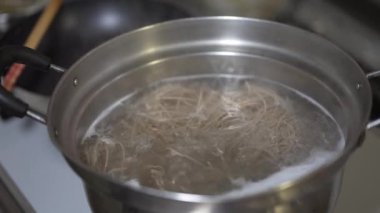 Soba şehriyelerinin nasıl kaynatıldığının resmi.