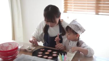 Parents and children making sweets