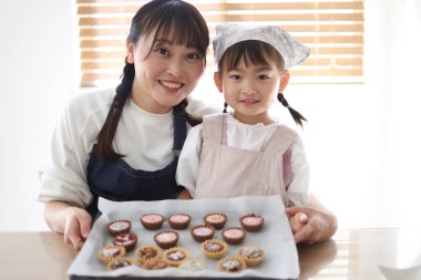 Parents and children making sweets