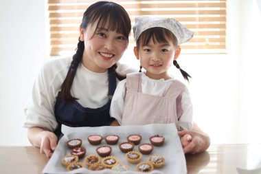 Parents and children making sweets