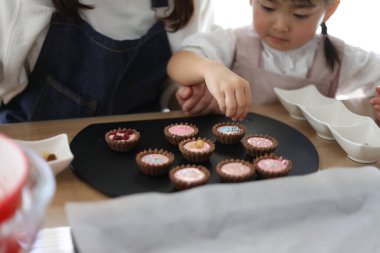 Parents and children making sweets