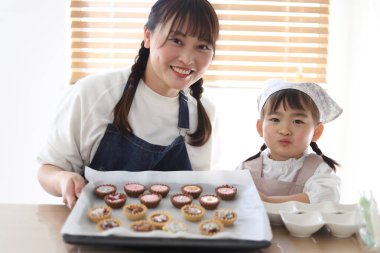 Parents and children making sweets